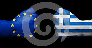 Flag of European Union and Greece painted on two clenched fists