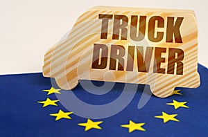 On the flag of the European Union stands a truck with the inscription - Truck driver