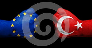 Flag of European Union and Turkey painted on two clenched fists