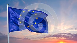 Flag of the European Union waving in the wind on flagpole against background of the sunrise