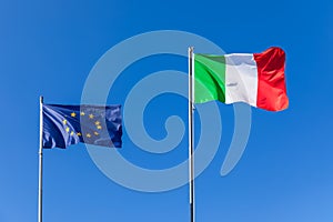 Flag of European Unione and flag of Italy against the blue sky photo