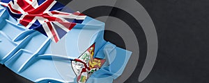 Flag of Fiji. Fabric textured Fiji flag isolated on dark background. 3D illustration