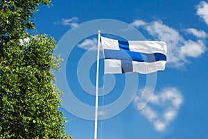 Flag of Finland on sky background.