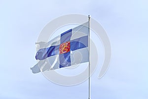 Flag of Finland with on a white flagpole