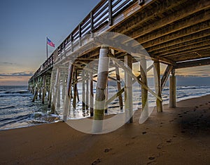 Flag Flying in the Predawn on a Fishing Pier