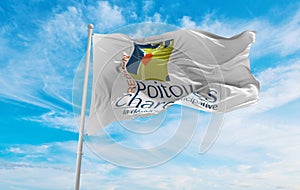 flag of former Region of Poitou Charentes, France at cloudy sky background on sunset, panoramic view. French travel and patriot