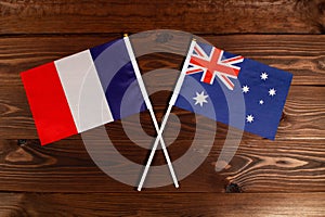 Flag of France and flag of Australia crossed with each other. The image illustrates the relationship between countries