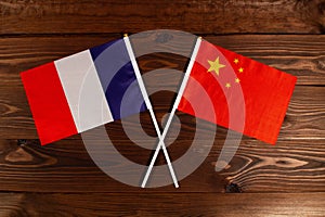 Flag of France and flag of China crossed with each other. The image illustrates the relationship between countries