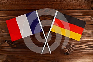 Flag of France and flag of Germany crossed with each other. The image illustrates the relationship between countries