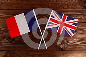 Flag of France and flag of Great Britain crossed with each other. The image illustrates the relationship between countries