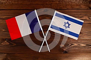 Flag of France and flag of Israel crossed with each other. The image illustrates the relationship between countries