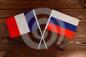 Flag of France and flag of Russia crossed with each other. The image illustrates the relationship between countries