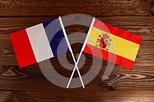Flag of France and flag of Spain crossed with each other. The image illustrates the relationship between countries