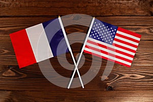Flag of France and flag of USA crossed with each other. The image illustrates the relationship between countries