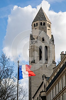 The flag of France in front of Saint Pierre of Chaillot Catholic Church in Paris, France