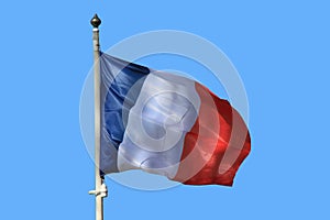 Flag of France waving in the wind on the blue sky background