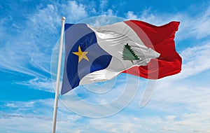 flag of French ancestry New England Acadians at cloudy sky background, panoramic view. flag representing extinct country,ethnic