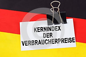 On the flag of Germany lies a business card with the inscription - core consumer price index