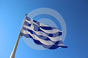 Flag of Greece with the cloudless blue sky in the background