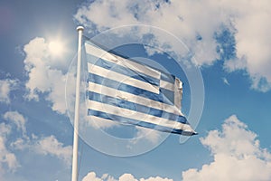 Flag of Greece, National symbol waving against cloudy, blue sky, sunny day