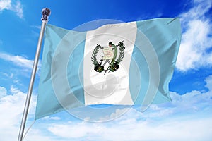 Flag of Guatemala developing against a clear blue sky