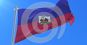 Flag of Haiti waving at wind with blue sky, loop