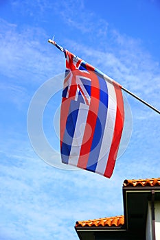 Flag of Hawaii floating on a blue sky