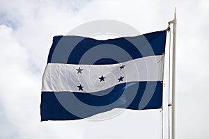 Flag of Honduras  waving against cloudy sky