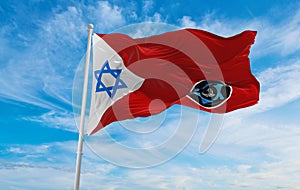 flag of IDF Manpower Directorate , Israel at cloudy sky background on sunset, panoramic view. Israeli travel and patriot concept.