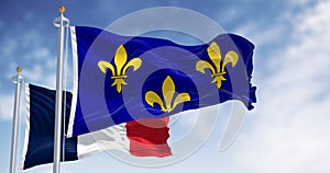 Flag of Ile de France waving with national french flag photo