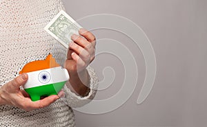 Flag of India on money bank in Indian woman hands. Dotations, pension fund, poverty, wealth, retirement concept