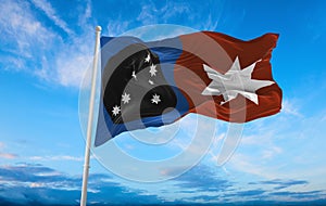 flag of Indigenous Australian peoples Anangu at cloudy sky background, panoramic view. flag representing ethnic group or culture, photo