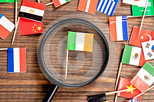 Flag of Ireland. Magnifying glass on wooden table