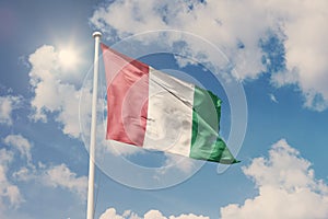 Flag of Italy, National symbol waving against cloudy, blue sky, sunny day