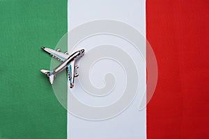 Flag of Italy and the plane. The concept of travel.