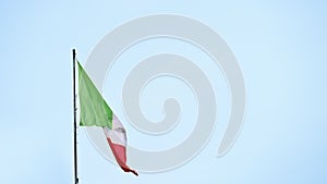 The flag of Italy waving outside on a bl