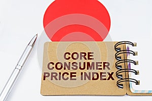 On the flag of Japan lies a pen and a notebook with the inscription - core consumer price index