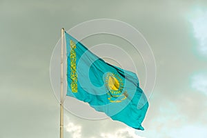 Flag of Kazakhstan on sky background. Waving flag of Republic of Kazakhstan