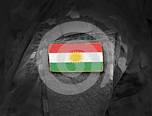 Flag of Kurdistan on soldiers arm. Flag of Kurdistan on military uniforms collage photo