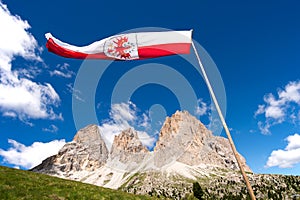 Flag Ladin abreast of Sella in Val Gardena with the Sella Group