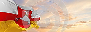 flag of Lublin Voivodeship, wojewodztwo lubelskie , Poland at cloudy sky background on sunset, panoramic view. Polish travel and