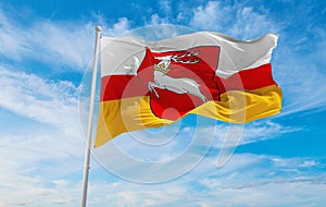 flag of Lublin Voivodeship, wojewodztwo lubelskie , Poland at cloudy sky background on sunset, panoramic view. Polish travel and