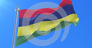 Flag of Mauritius waving at wind with blue sky in slow, loop
