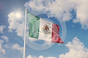 Flag of Mexico, National symbol waving against cloudy, blue sky, sunny day