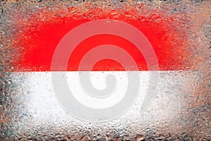 Flag of Monaco. Flag of Monaco on the background of water drops. Flag with raindrops. Splashes on glass