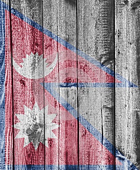 Flag of Nepal on weathered wood