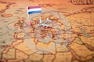 The flag of the Netherlands and the plane on the world map