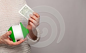 Flag of Nigeria on money bank in Nigerian woman hands. Dotations, pension fund, poverty, wealth, retirement concept