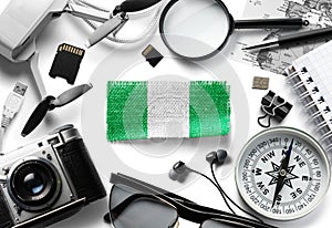 Flag of Nigeria and travel accessories on a white background.