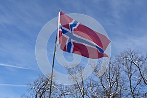 Flag of Norway flown on blue sky